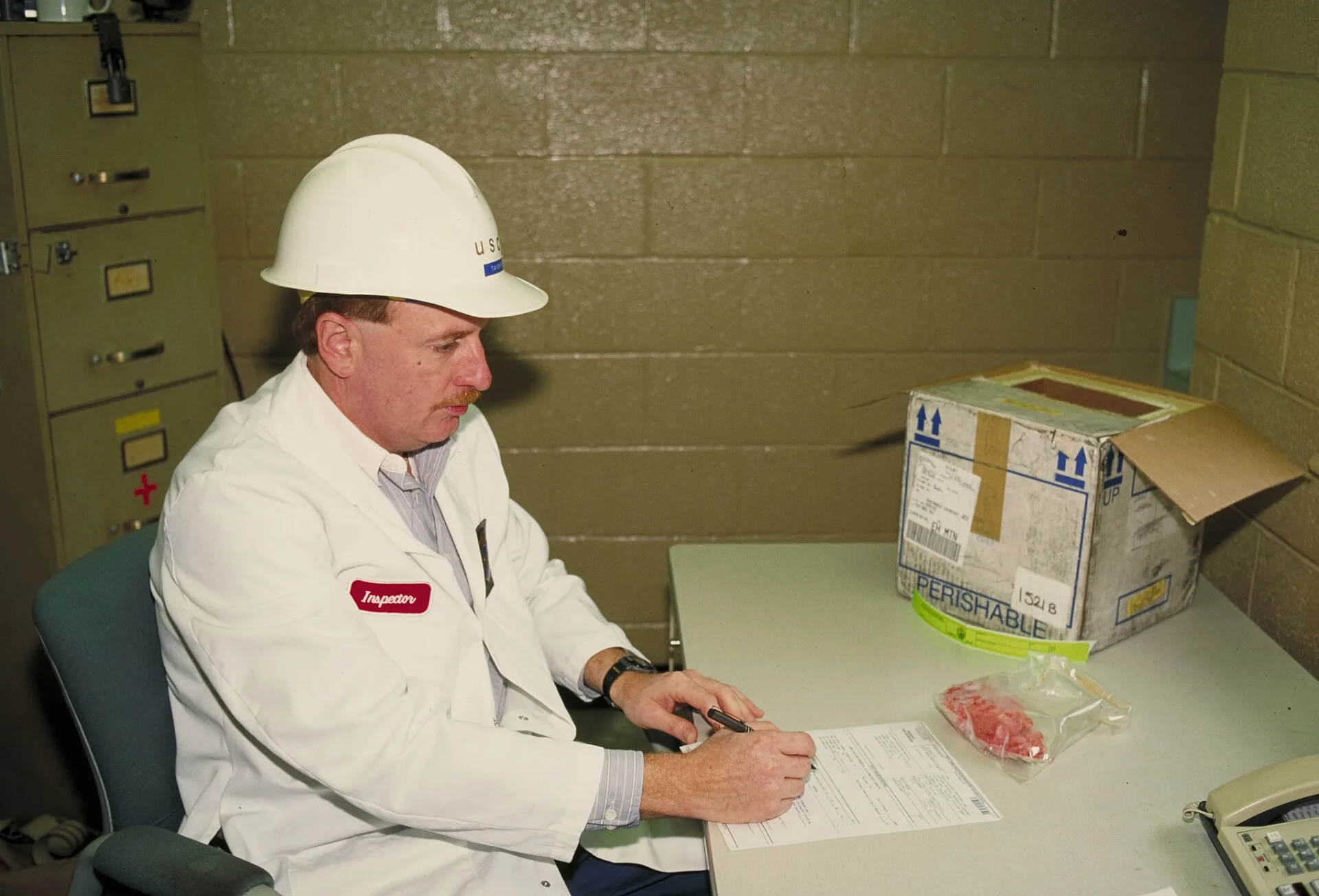 U.S. Department of Agriculture (USDA) Food Safety Inspection Service (FSIS) inspector prepares paperwork and meat samples to ship for microbiological analysis to verify the adequacy of the Hazard Analysis and Critical Control Points (HACCP) issued by FSIS on June 15, 1995. USDA photo Lester Shepherd. What paperwork a specialty food business needs to operate for a small operation